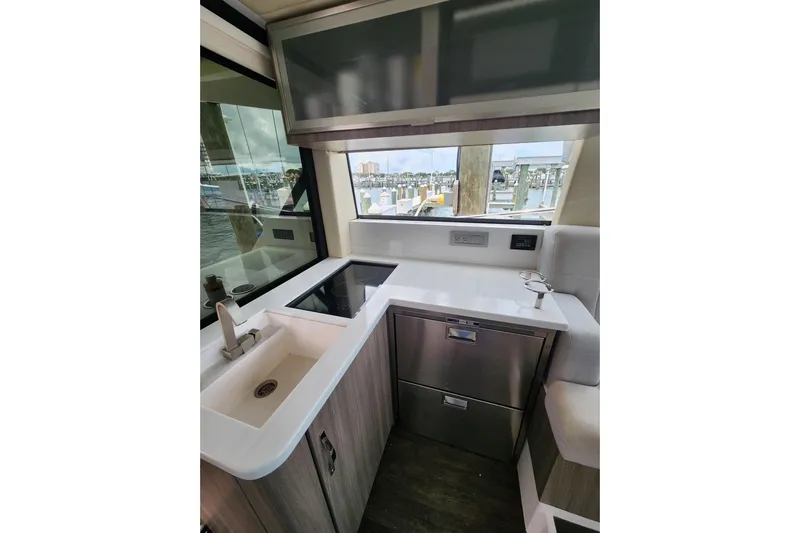  Yacht Photos Pics Modern kitchen area in 2020 Regal 38 XO yacht with sleek design and waterfront view.