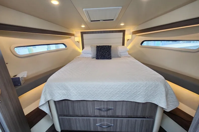  Yacht Photos Pics Luxurious cabin interior of 2020 Regal 38 XO yacht with cozy bed and modern design.