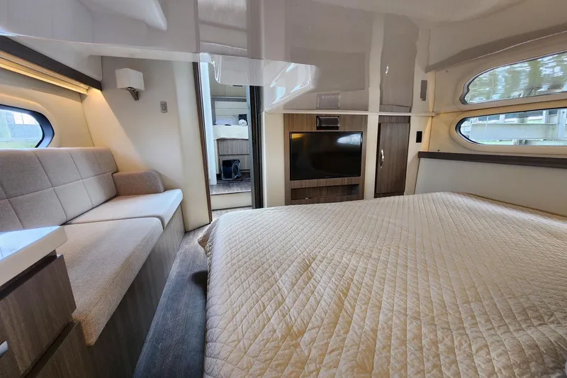  Yacht Photos Pics Luxurious interior of 2020 Regal 38 XO yacht with cozy bed and seating area.
