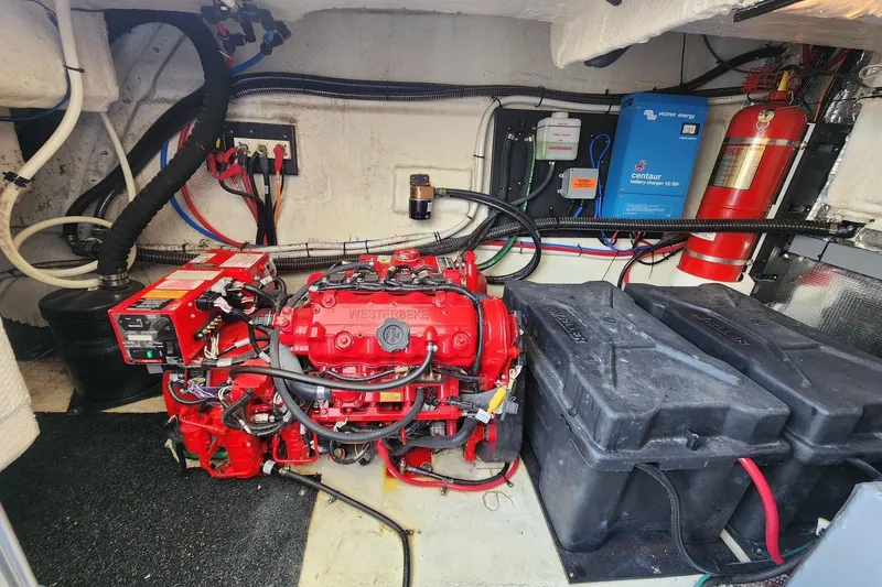  Yacht Photos Pics Engine room of 2020 Regal 38 XO with red Westerbeke generator and battery charger.