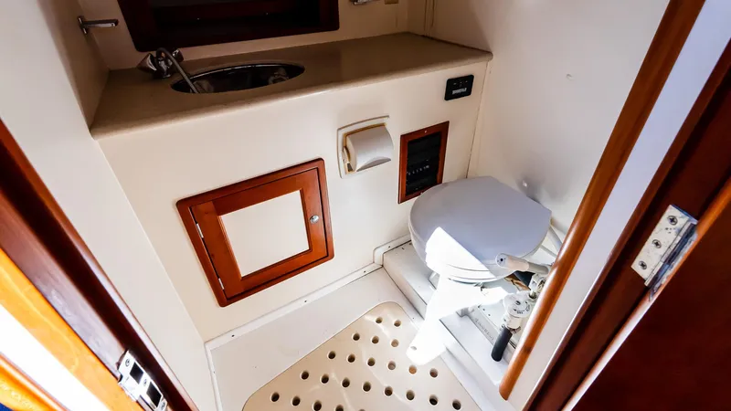 Freestyle Yacht Photos Pics 1998 Little Harbor WhisperJet 38 bathroom with toilet, sink, and wooden accents.