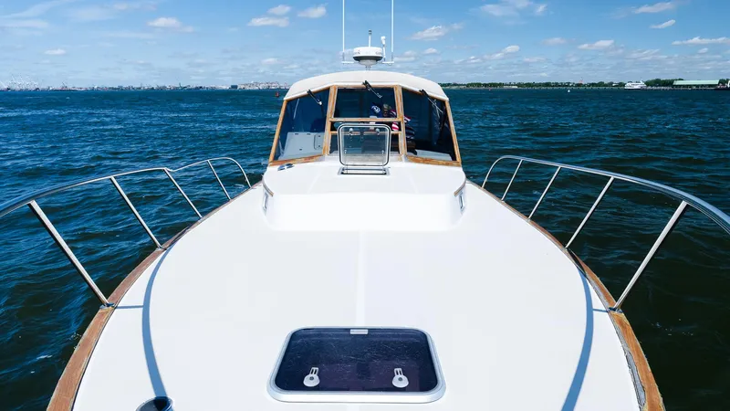 Freestyle Yacht Photos Pics 1998 Little Harbor WhisperJet 38 yacht on open water, clear sky, and distant shoreline.