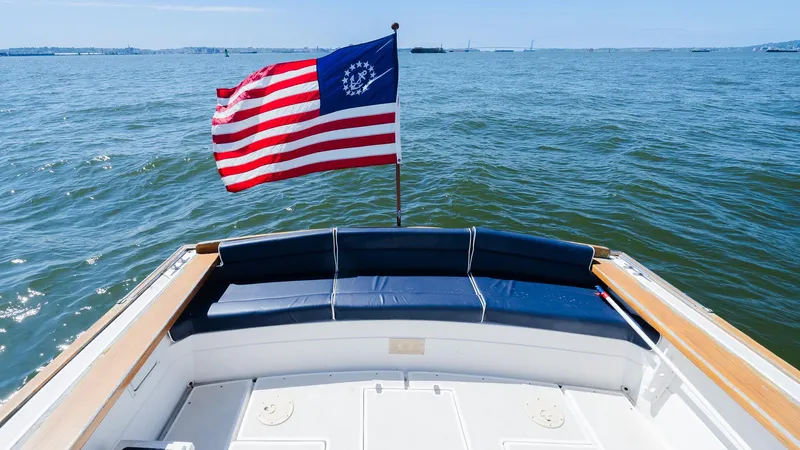 Freestyle Yacht Photos Pics Little Harbor WhisperJet 38 boat with American flag on open water, 1998 model.