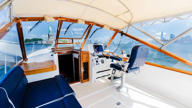 Freestyle Yacht Photos Pics Interior view of 1998 Little Harbor WhisperJet 38 yacht with blue seating and wooden accents.