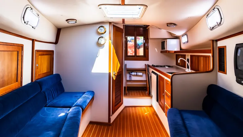 Freestyle Yacht Photos Pics Interior of 1998 Little Harbor WhisperJet 38 yacht with blue seating and wooden finishes.