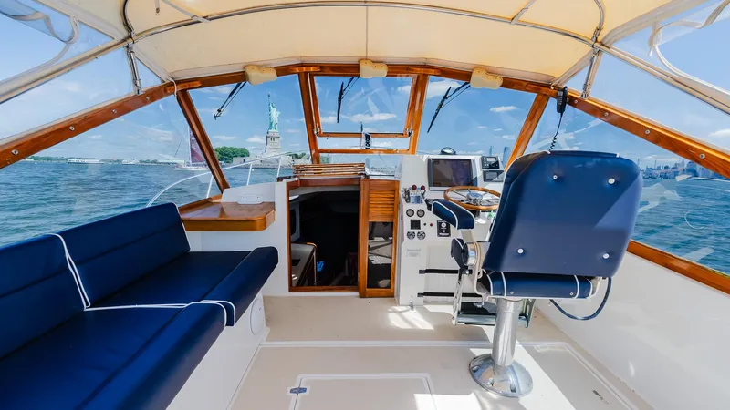 Freestyle Yacht Photos Pics Cockpit of 1998 Little Harbor WhisperJet 38 with blue seating and steering wheel.