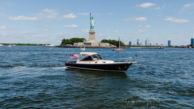 Freestyle Yacht Photos Pics Little Harbor WhisperJet 38 boat near Statue of Liberty, 1998 model, sailing in New York Harbor.