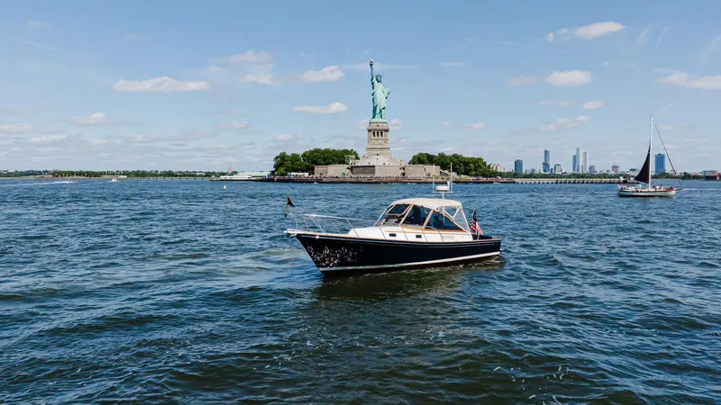 Freestyle Yacht Photos Pics Little Harbor WhisperJet 38 boat near Statue of Liberty, 1998 model.