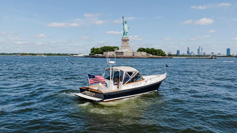 Freestyle Yacht Photos Pics Little Harbor WhisperJet 38 boat near Statue of Liberty, 1998 model, sunny day.