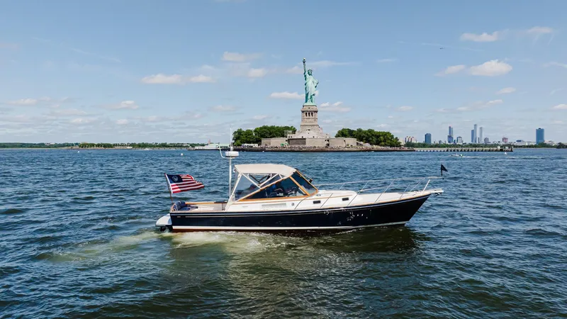 Freestyle Yacht Photos Pics Little Harbor WhisperJet 38 boat near Statue of Liberty, 1998 model, sunny day.