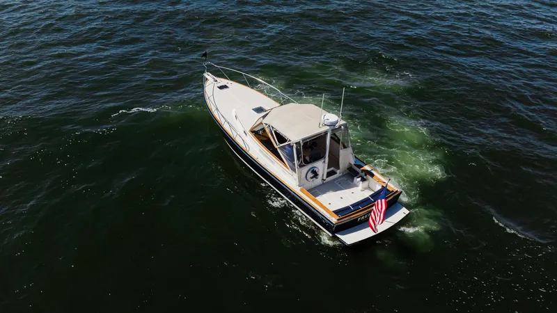 Freestyle Yacht Photos Pics 1998 Little Harbor WhisperJet 38 cruising on open water, displaying an American flag.