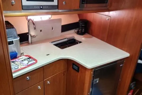 Yacht Photos Pics 2007 Tiara Yachts 3600 Open galley with sink, stove, and wooden cabinetry.