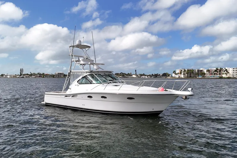  Yacht Photos Pics 2007 Tiara Yachts 3600 Open cruising on a sunny day with coastal buildings in the background.