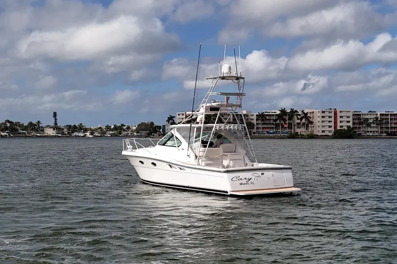  Yacht Photos Pics 2007 Tiara Yachts 3600 Open cruising on a scenic waterway under a cloudy sky.