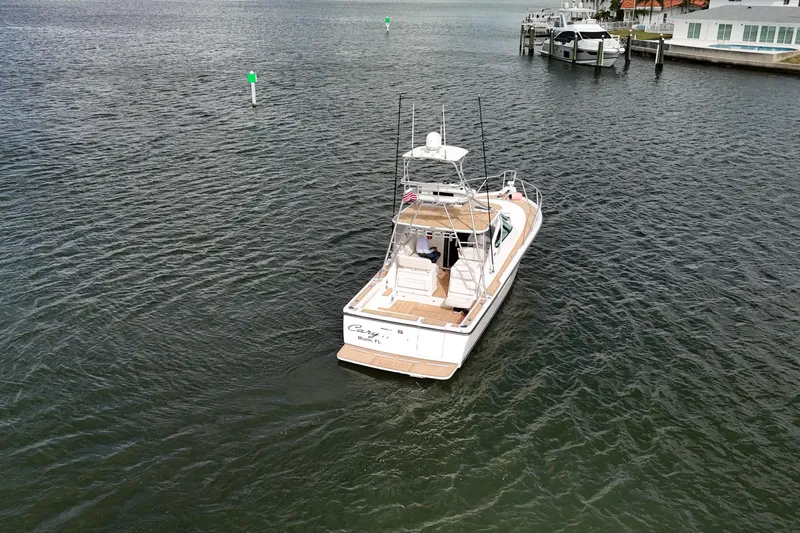  Yacht Photos Pics 2007 Tiara Yachts 3600 Open cruising on calm waters near a dock.
