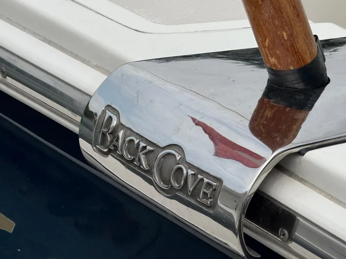 Skookum Yacht Photos Pics Close-up of 2009 Back Cove 29 boat nameplate with wooden detail.