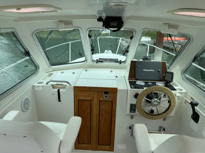 Skookum Yacht Photos Pics 2009 Back Cove 29 boat interior with steering wheel and navigation equipment.