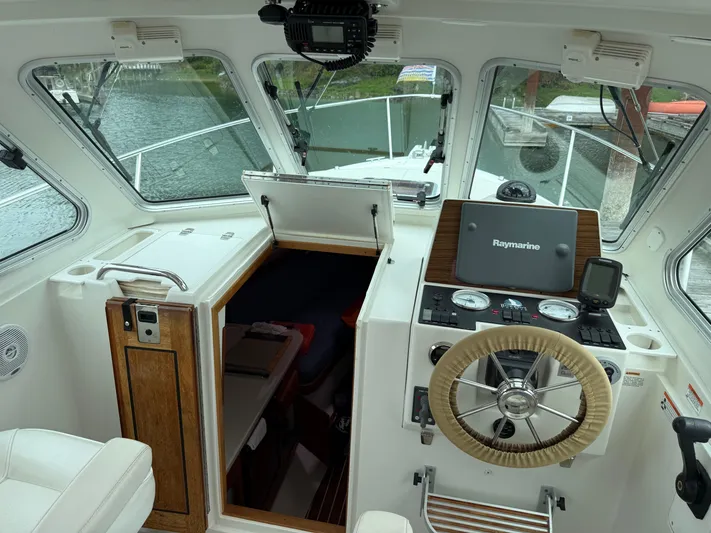 Skookum Yacht Photos Pics 2009 Back Cove 29 boat interior with steering wheel and navigation equipment.