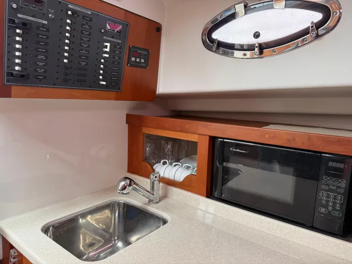 Skookum Yacht Photos Pics 2009 Back Cove 29 yacht interior with sink, microwave, and control panel.