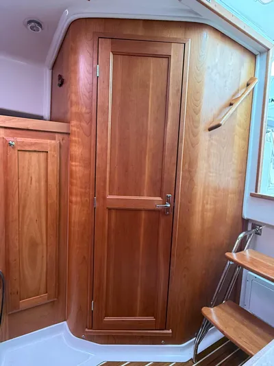 Skookum Yacht Photos Pics 2009 Back Cove 29 interior with wooden cabinetry and door, showcasing elegant marine craftsmanship.