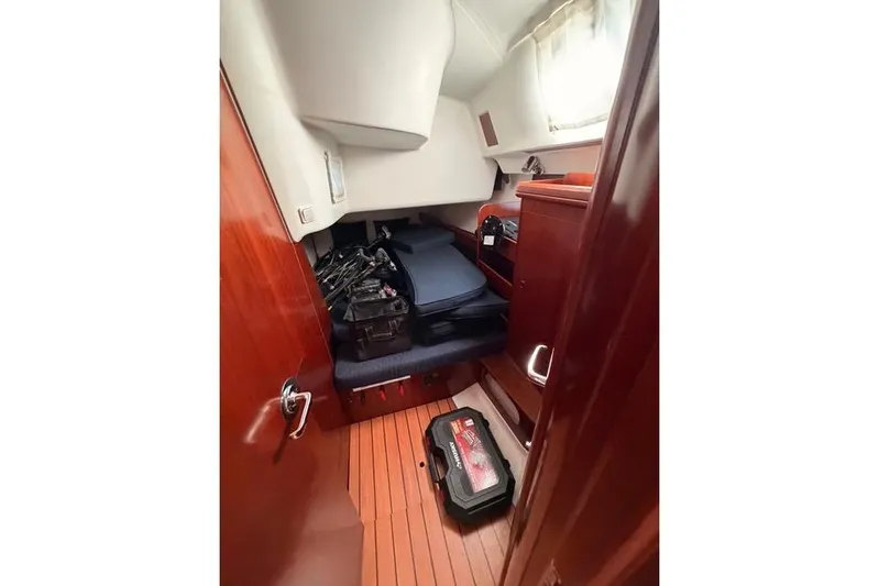 Solmare Yacht Photos Pics Cabin interior of 2005 Beneteau Oceanis Clipper 423 with wooden flooring and storage.