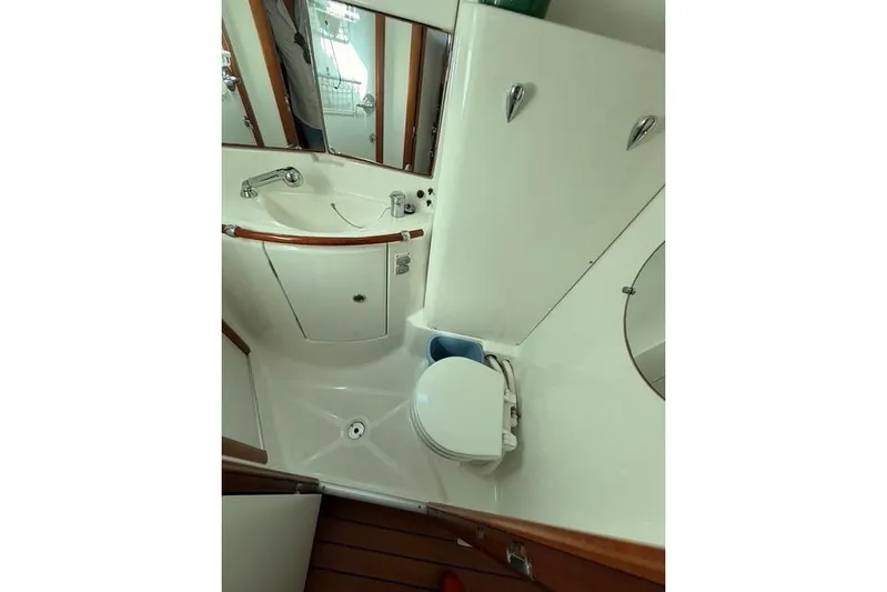 Solmare Yacht Photos Pics Bathroom interior of 2005 Beneteau Oceanis Clipper 423 yacht, featuring sink and toilet.
