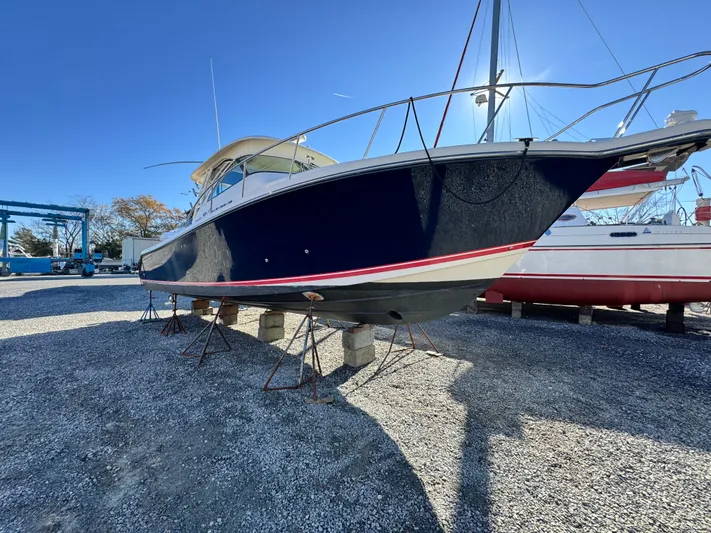 In Pursuit Yacht Photos Pics 2011 Pursuit OS 375 Offshore boat on stands outdoors.