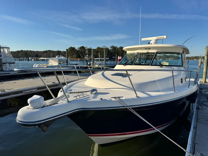 In Pursuit Yacht Photos Pics 2011 Pursuit OS 375 Offshore boat docked at marina.