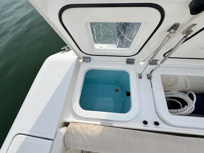 In Pursuit Yacht Photos Pics Pursuit OS 375 Offshore 2011, open storage hatch on a boat.