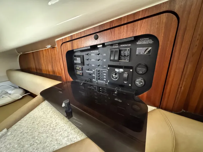 In Pursuit Yacht Photos Pics Control panel of 2011 Pursuit OS 375 Offshore with wood paneling.