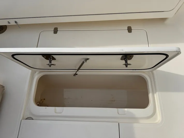 In Pursuit Yacht Photos Pics Open storage compartment on a 2011 Pursuit OS 375 Offshore boat.