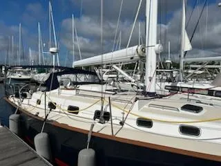 Tangaroa Yacht Photos Pics 2015 Tartan 4000 sailboat docked at marina under cloudy sky.