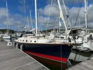 Tangaroa Yacht Photos Pics Sailboat docked at marina, Tartan 4000 model, 2015, with blue hull and red stripe.