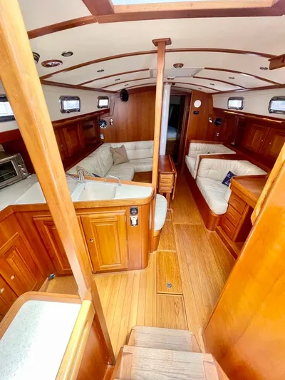 Tangaroa Yacht Photos Pics Interior of 2015 Tartan 4000 sailboat with wooden finishes and cozy seating area.