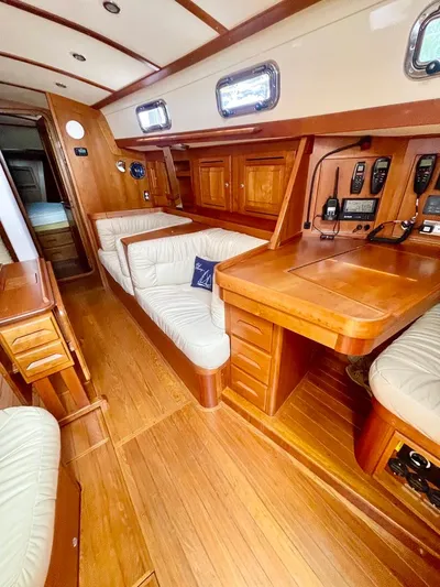 Tangaroa Yacht Photos Pics Interior of 2015 Tartan 4000 sailboat with wood finish and comfortable seating.