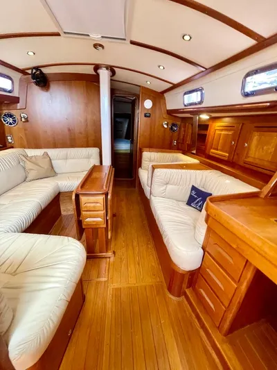 Tangaroa Yacht Photos Pics Luxurious interior of 2015 Tartan 4000 yacht with elegant wood finish and plush seating.