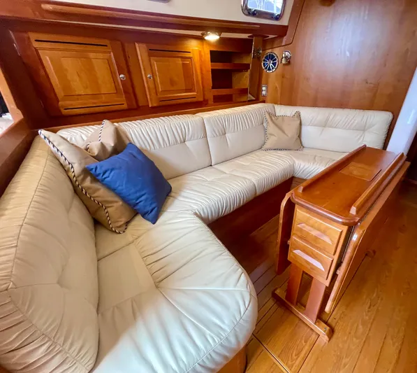 Tangaroa Yacht Photos Pics Luxurious Tartan 4000 yacht interior with cream leather seating and wooden accents, 2015 model.