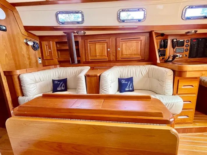 Tangaroa Yacht Photos Pics Luxurious interior of 2015 Tartan 4000 yacht with plush seating and wooden cabinetry.