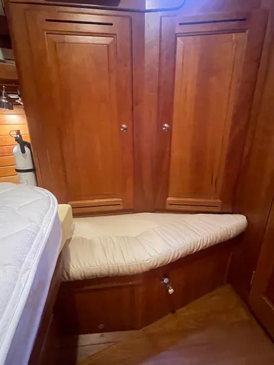 Tangaroa Yacht Photos Pics Wooden interior of 2015 Tartan 4000 yacht with cushioned seating and storage cabinets.