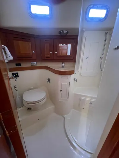 Tangaroa Yacht Photos Pics 2015 Tartan 4000 yacht bathroom with wooden cabinets and compact shower.