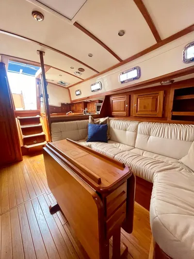 Tangaroa Yacht Photos Pics Interior of 2015 Tartan 4000 sailboat with wooden finishes and cozy seating area.