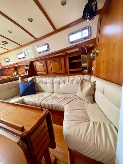 Tangaroa Yacht Photos Pics Luxurious interior of 2015 Tartan 4000 yacht with plush seating and wooden accents.