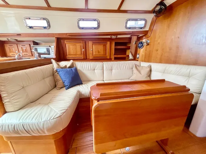 Tangaroa Yacht Photos Pics Luxurious interior of 2015 Tartan 4000 yacht with plush seating and wooden finishes.