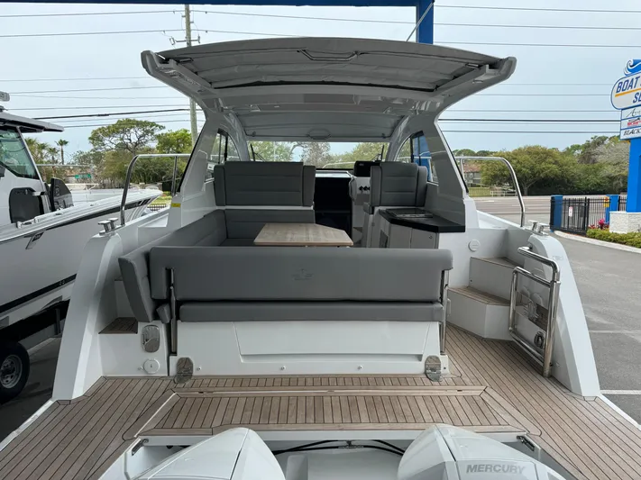  Yacht Photos Pics 2024 Sealine S335V yacht with spacious deck and seating area, showcasing modern design.