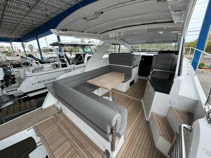  Yacht Photos Pics 2024 Sealine S335V yacht interior with sleek seating and wooden flooring.