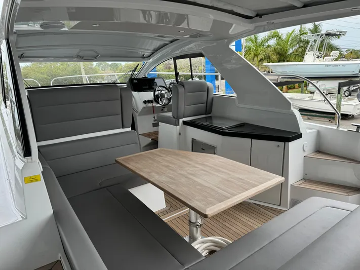  Yacht Photos Pics 2024 Sealine S335V yacht interior with modern seating and wooden table.