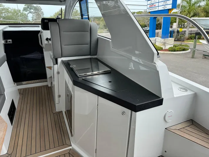  Yacht Photos Pics 2024 Sealine S335V boat interior with sleek seating and modern design.