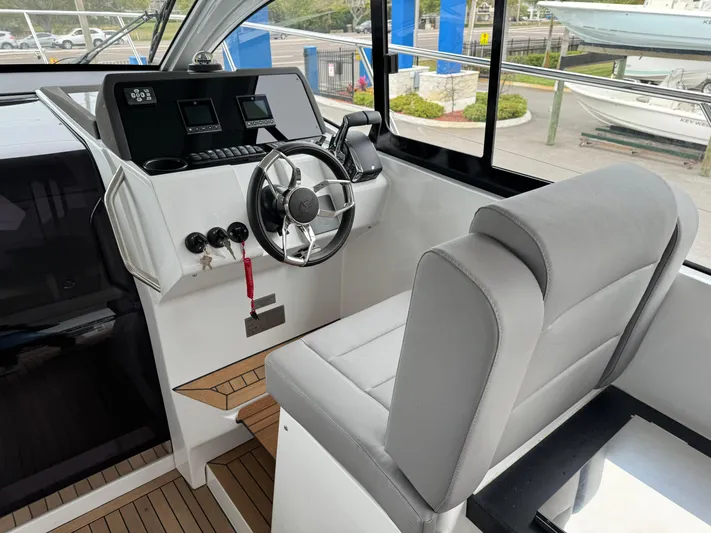  Yacht Photos Pics 2024 Sealine S335V boat cockpit with modern steering wheel and controls.