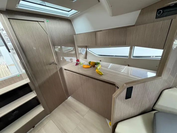  Yacht Photos Pics 2024 Sealine S335V yacht interior with modern wood finish and skylight.