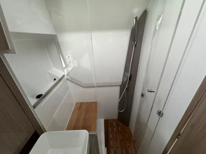  Yacht Photos Pics 2024 Sealine S335V yacht bathroom with modern shower and wooden accents.